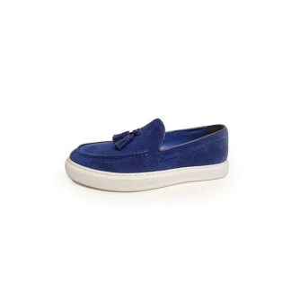 Royal blue suede loafer with a tassel on a white platform sole.