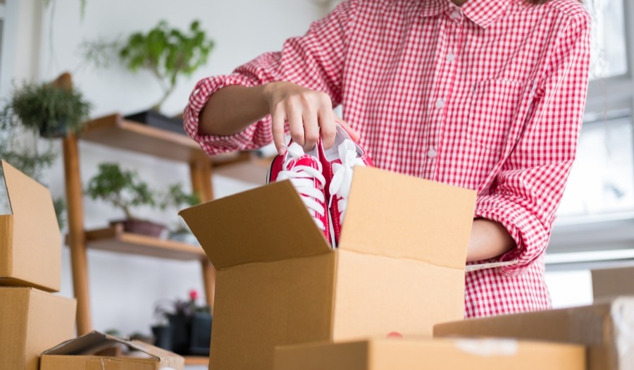 A person is packing shoes.