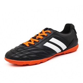 Black leather soccer shoes with orange laces and white stripes, featuring a durable sole for enhanced traction.