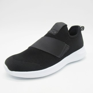 A black slip-on sneaker with a white sole and wide strap detail.