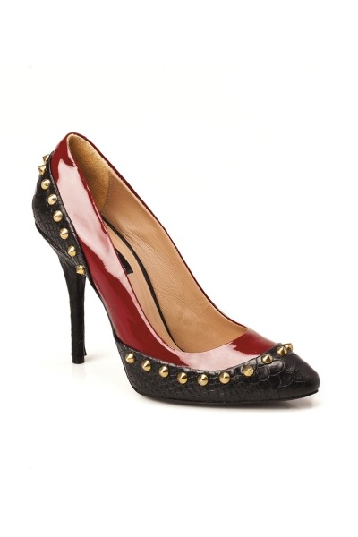 A pair of red and black high heels with a combination of patent leather and snakeskin pattern, featuring gold studs and a stylish pointed toe design.